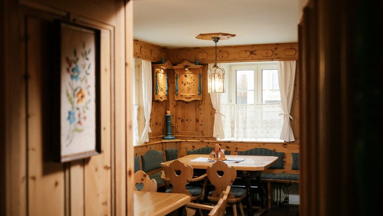 Cozy, rustic parlor with wooden furniture and decorative elements.