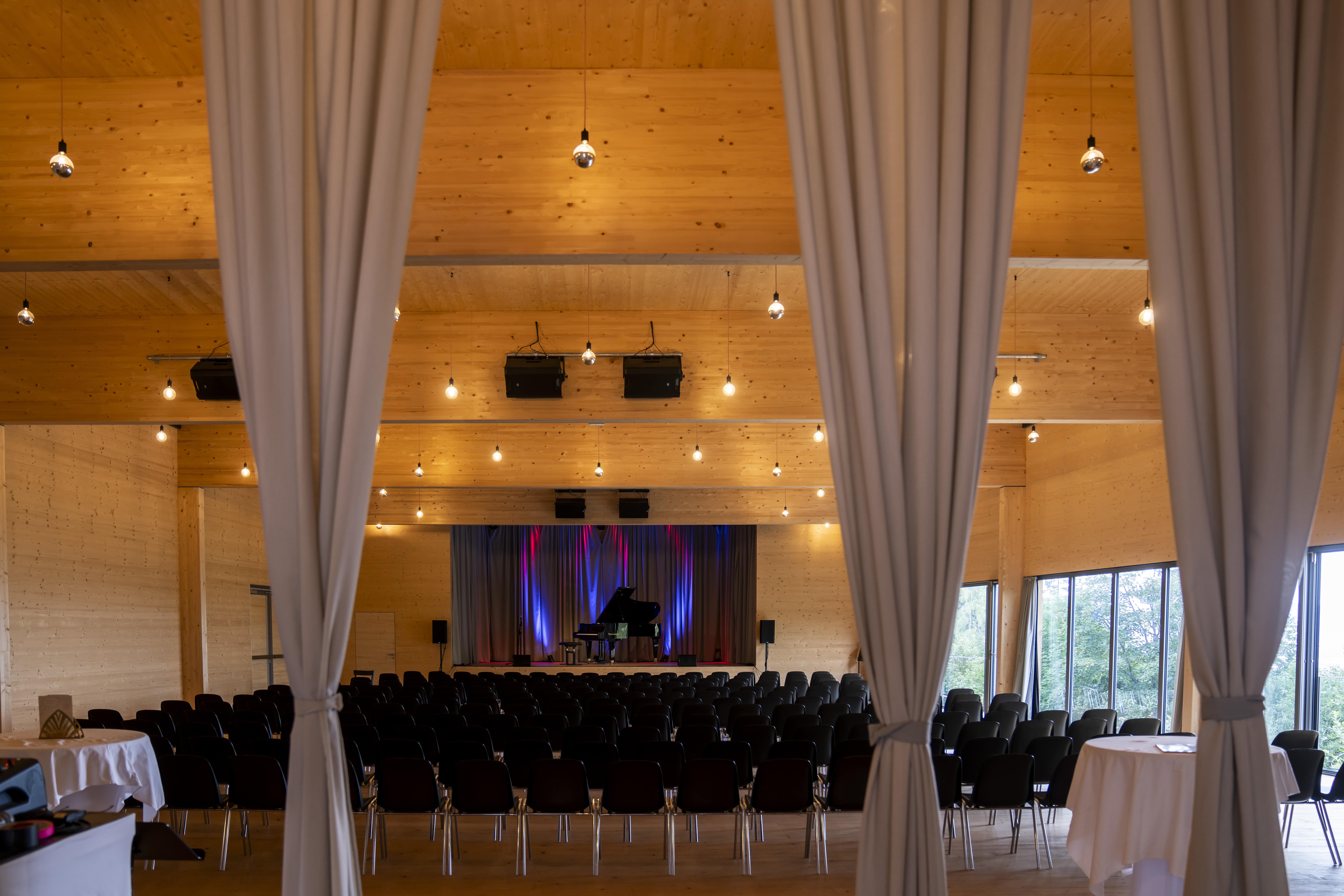 Event hall from behind with seating and stage