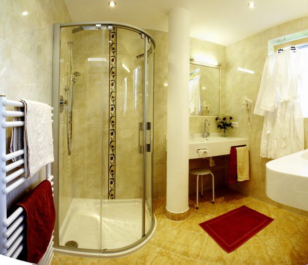 Modern bathroom with shower, washbasin and towel rail.