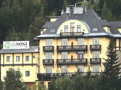 Yellow building with balconies and sign 'Renona Rehabilitation'.