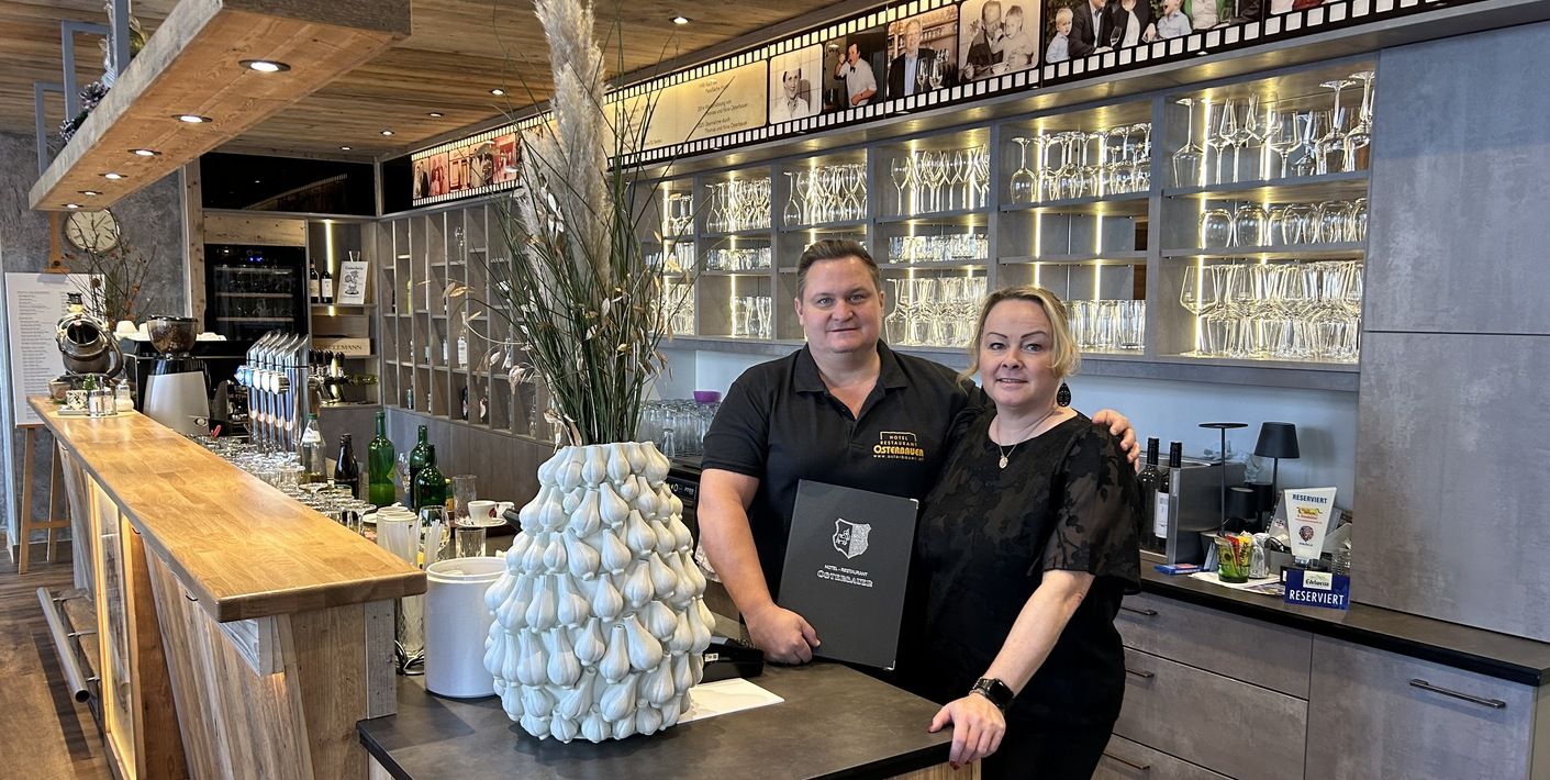 The Osterbauer family behind a bar in the Osterbauer restaurant.