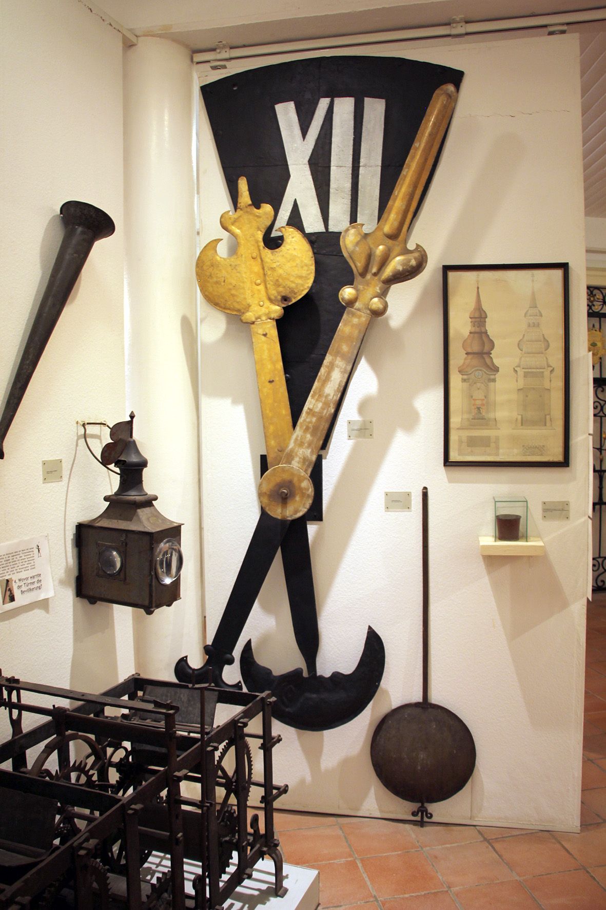 Exhibit in the Stockerau District Museum with old clock parts and drawings.