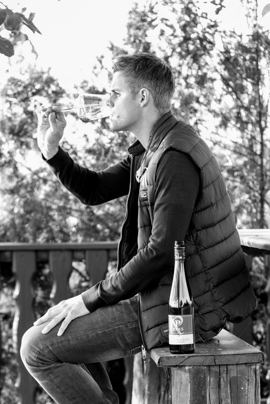 Man drinking wine on a terrace.