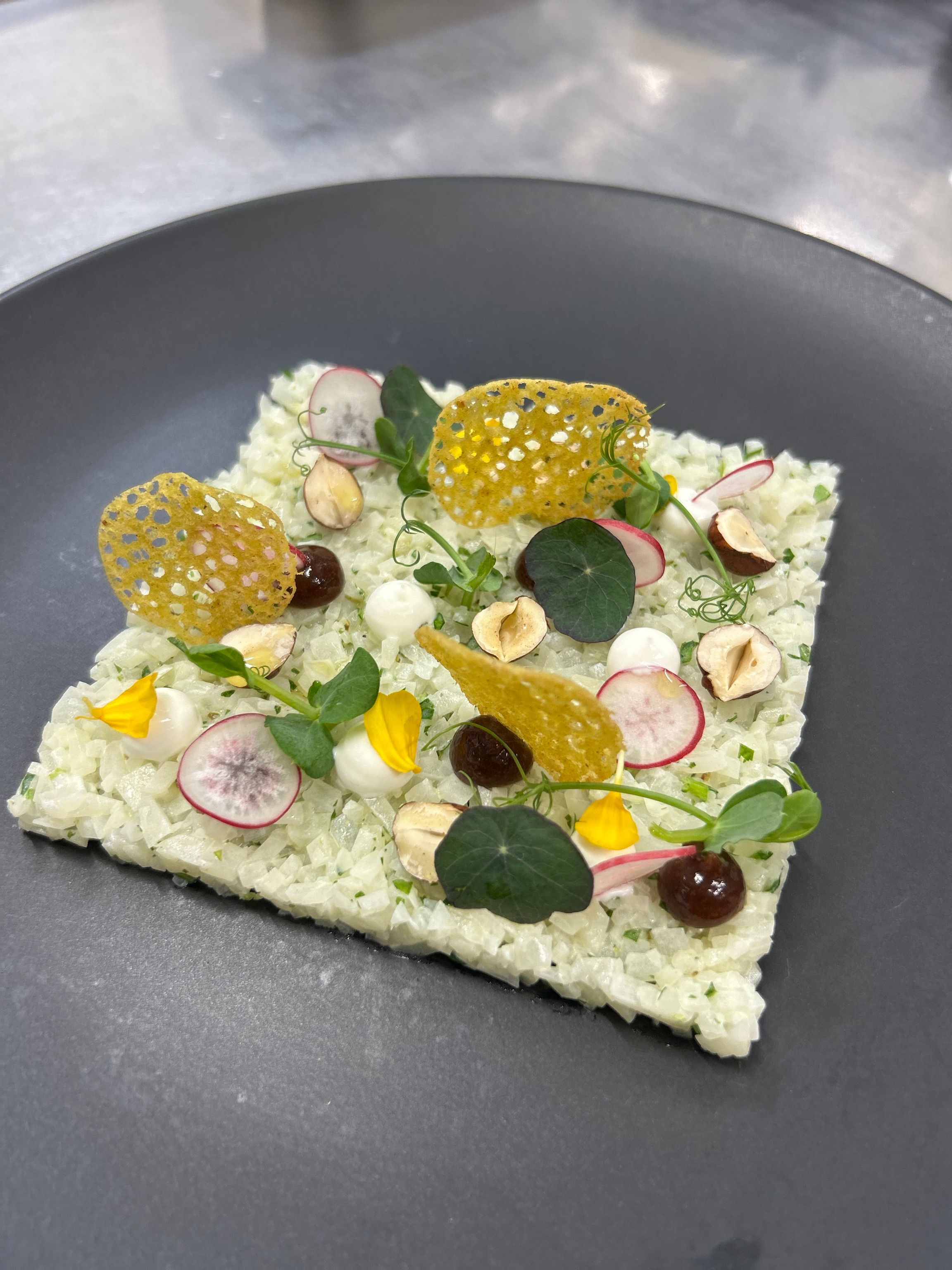 Kohlrabi & hazelnut baked in salt, kohlrabi tartare, raz el hanout tuile, powdered milk jam