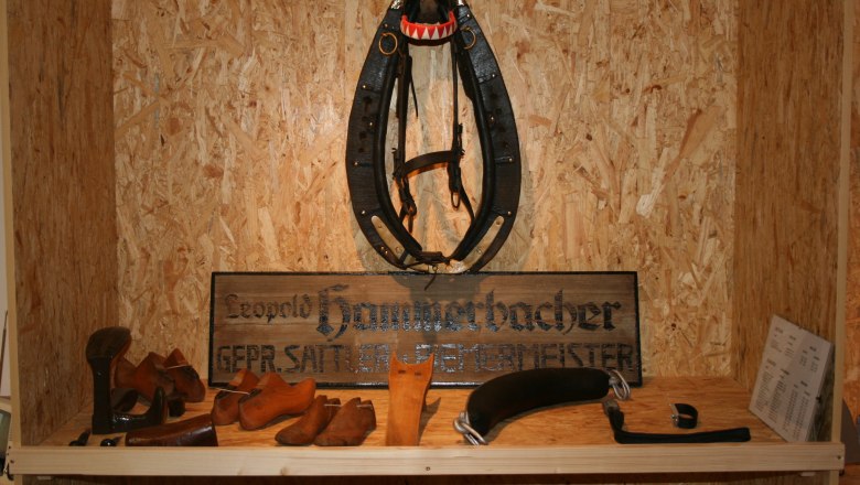 Exhibit in a museum with saddler's tools and a horse harness.