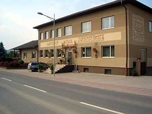 Two-storey building with the inscription 'Gasthof Kögl'.