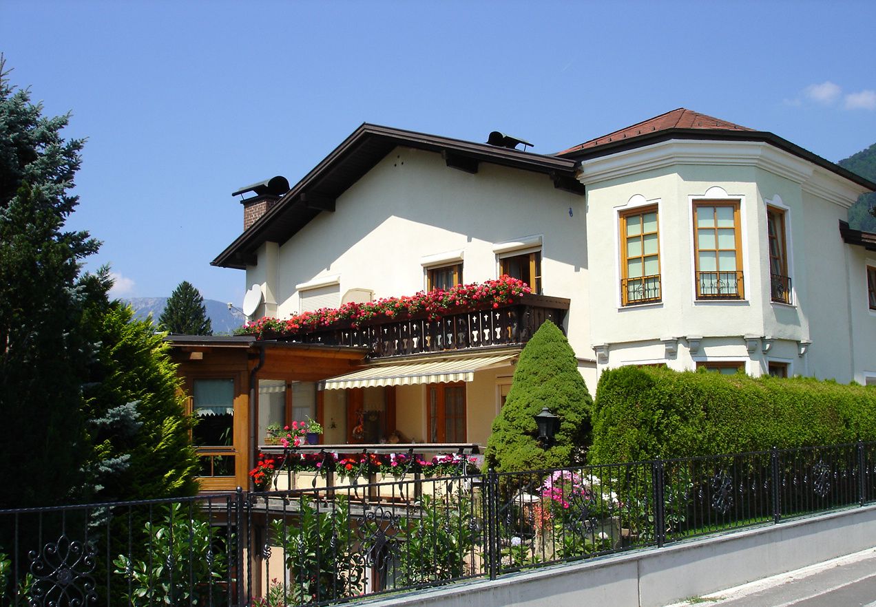White house with balcony and flowers