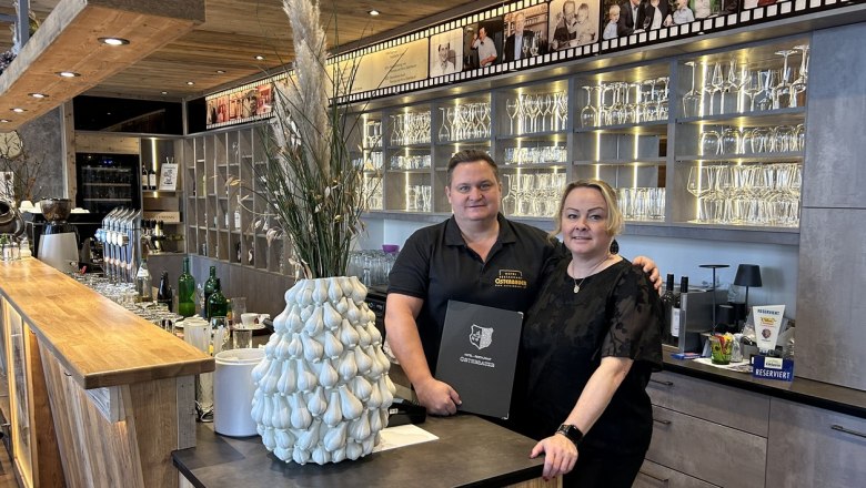 The Osterbauer family behind a bar in the Osterbauer restaurant.