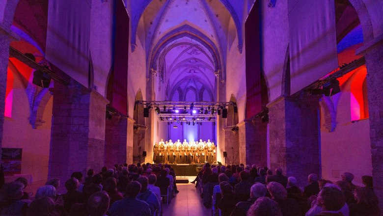 Interior view of the Minorite Church in Krems during a concert with illuminated choir.