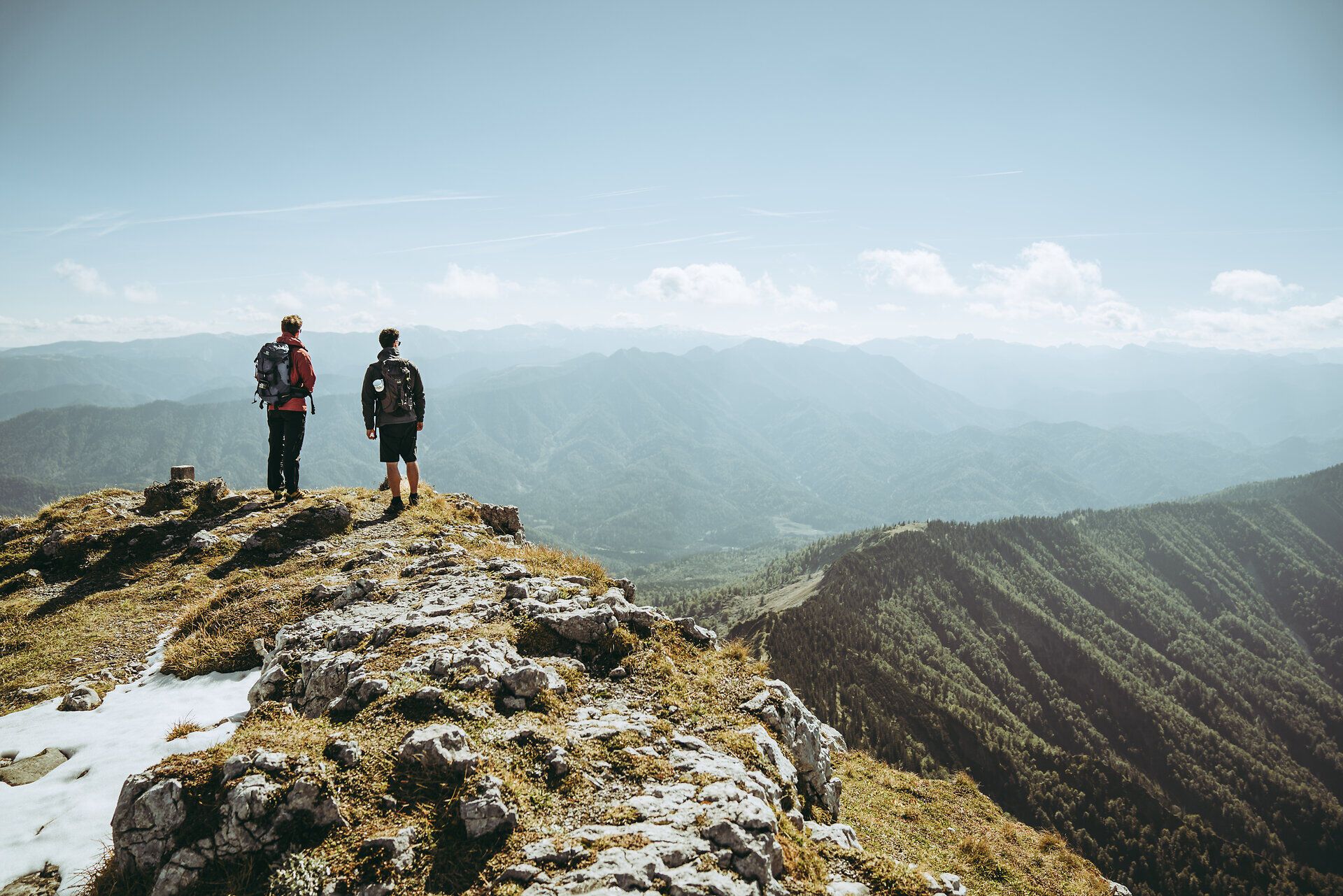Two hikers stand at the summit and enjoy the breathtaking view over the Ybbstal Alps. The fresh mountain air and majestic landscapes invite you to unwind and experience the beauty of nature.