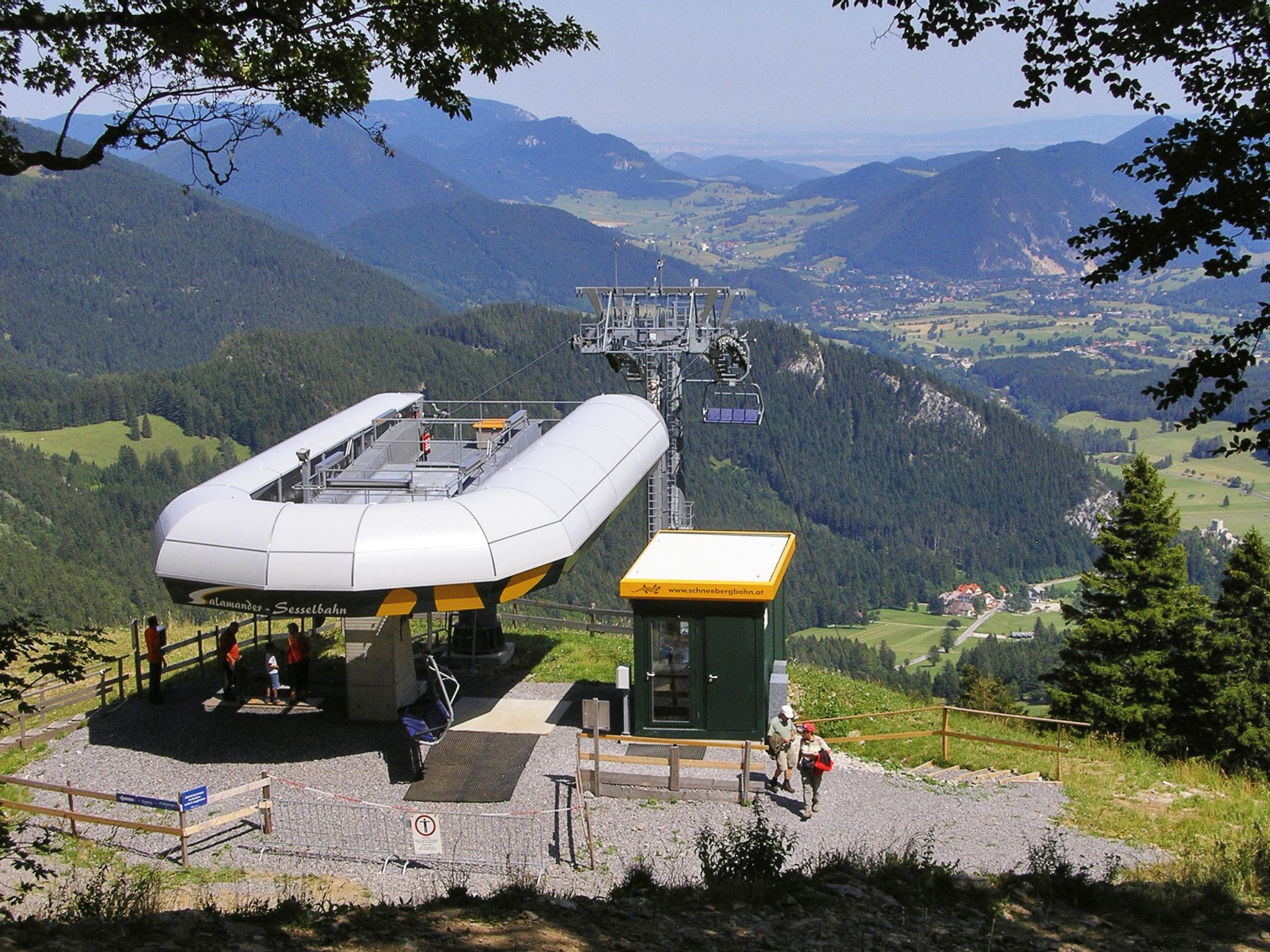 Summit station of the Schneeberg chairlift with a view of the surrounding mountains and valleys.