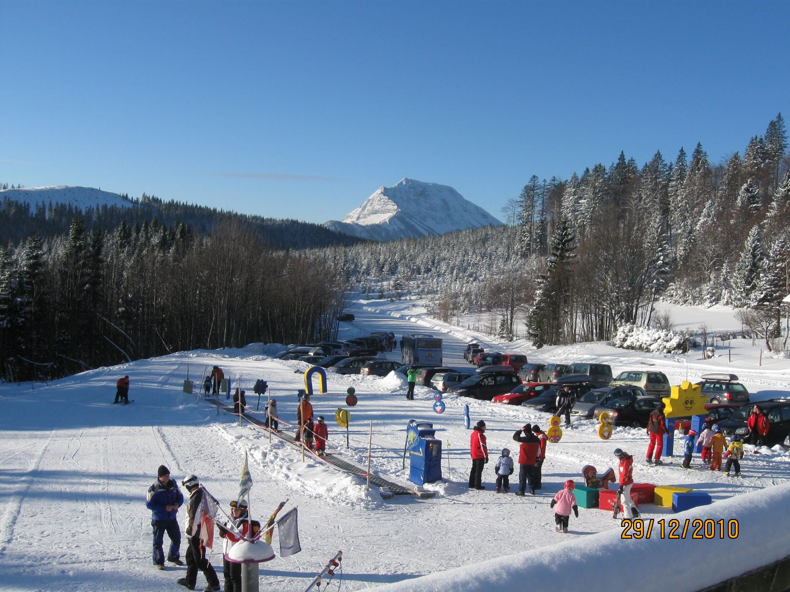 Winter landscape with ski lift and children playing in Puchenstuben.