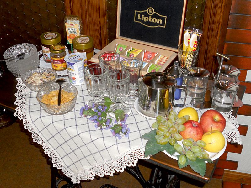 Breakfast buffet with various teas, fruit and spreads.