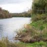 River landscape with trees and green banks.
