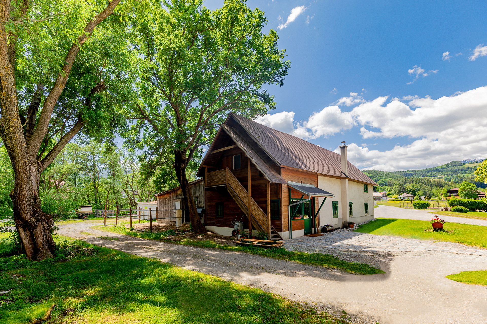 Renovated mill with modern loft, surrounded by trees and meadows.