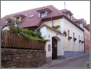 Traditional house with red tiled roof and flower boxes on the windows.