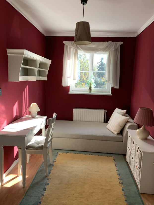 Bedroom with white country house furniture and red walls