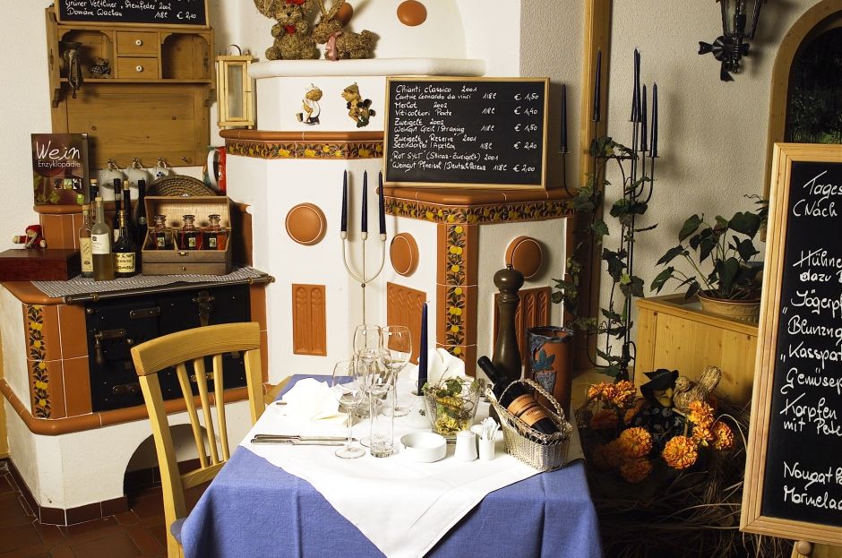 Cozy fireside lounge with set table, wine lists and decorations.