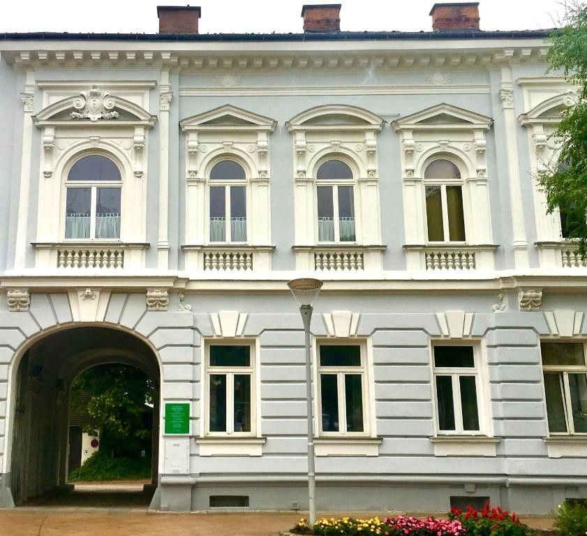Historic building with ornate windows and an archway.