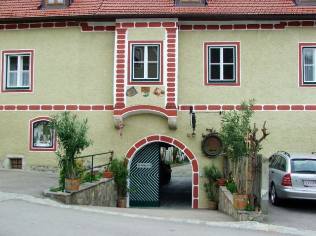 Historic building with archway and red bricks.