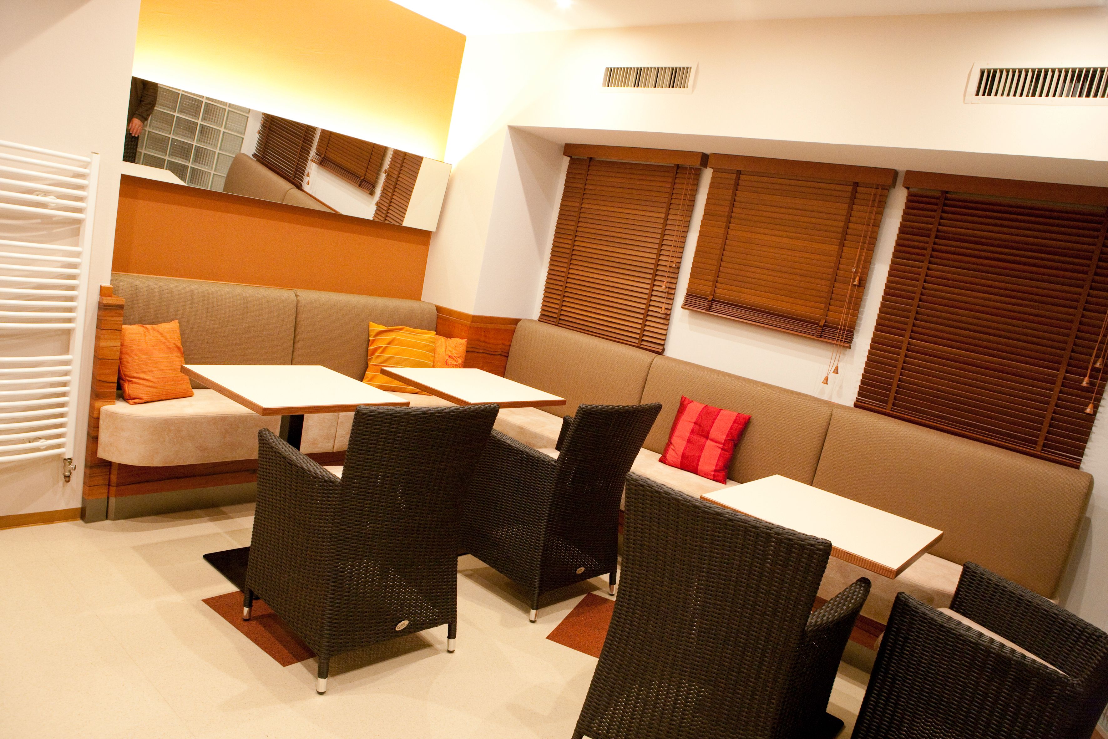 Cozy lounge area with sofas, tables and chairs.