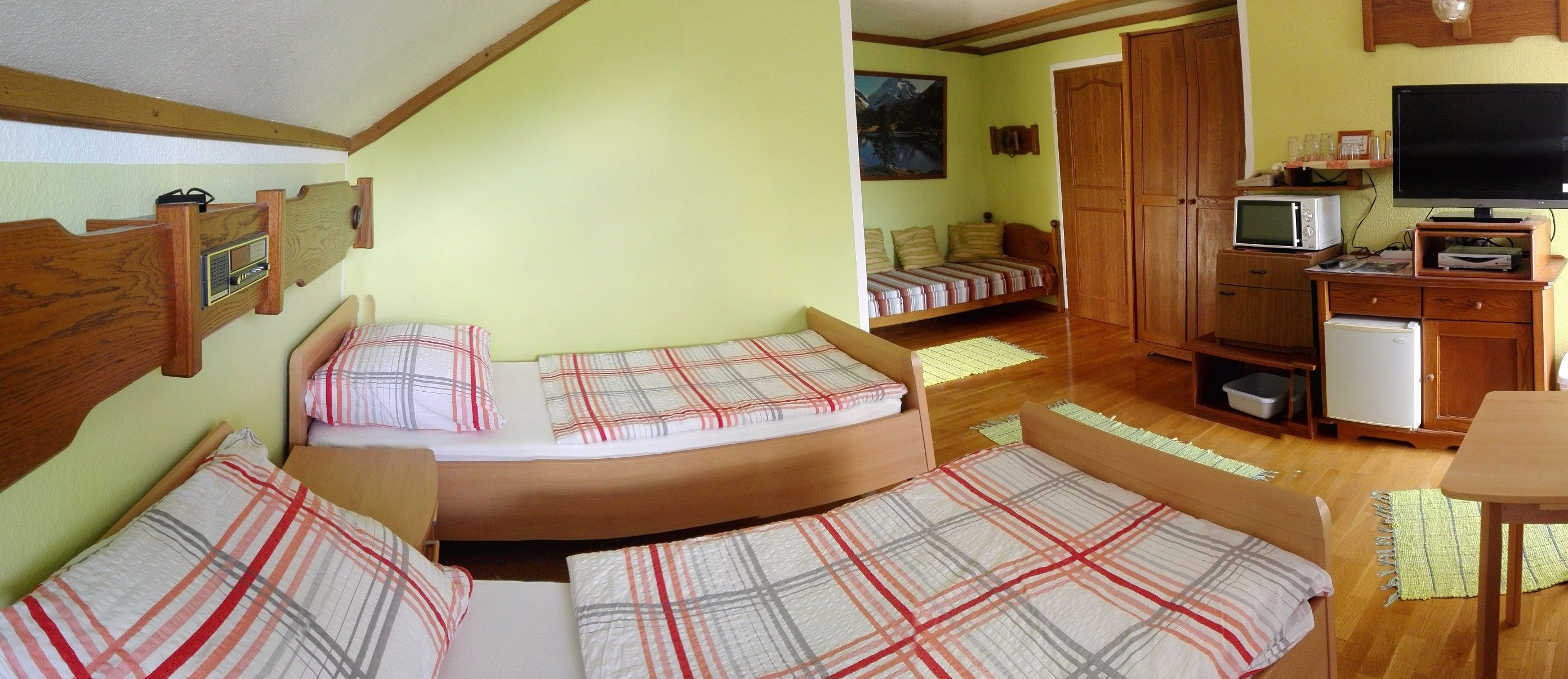 Comfortable room with two beds, TV, microwave and fridge.