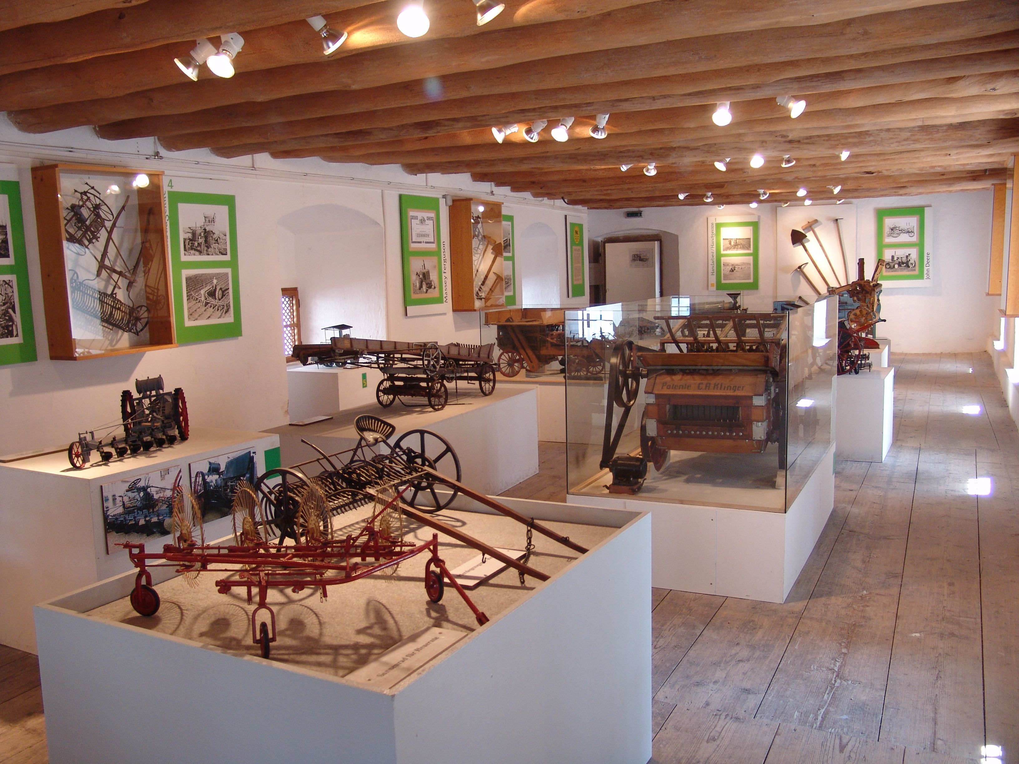 Exhibition of agricultural machinery models in a museum.