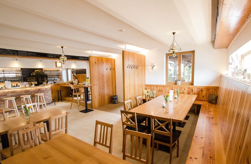 Cozy dining room with wooden furniture and bar.