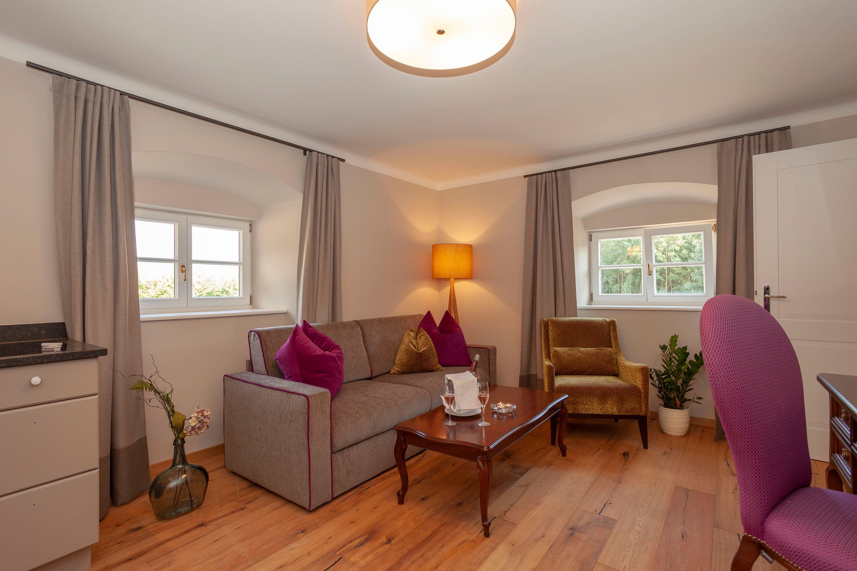 Elegant suite with sofa, armchair, table and decoration.