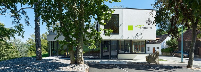 Modern wine pavilion in Hollenburg surrounded by trees.