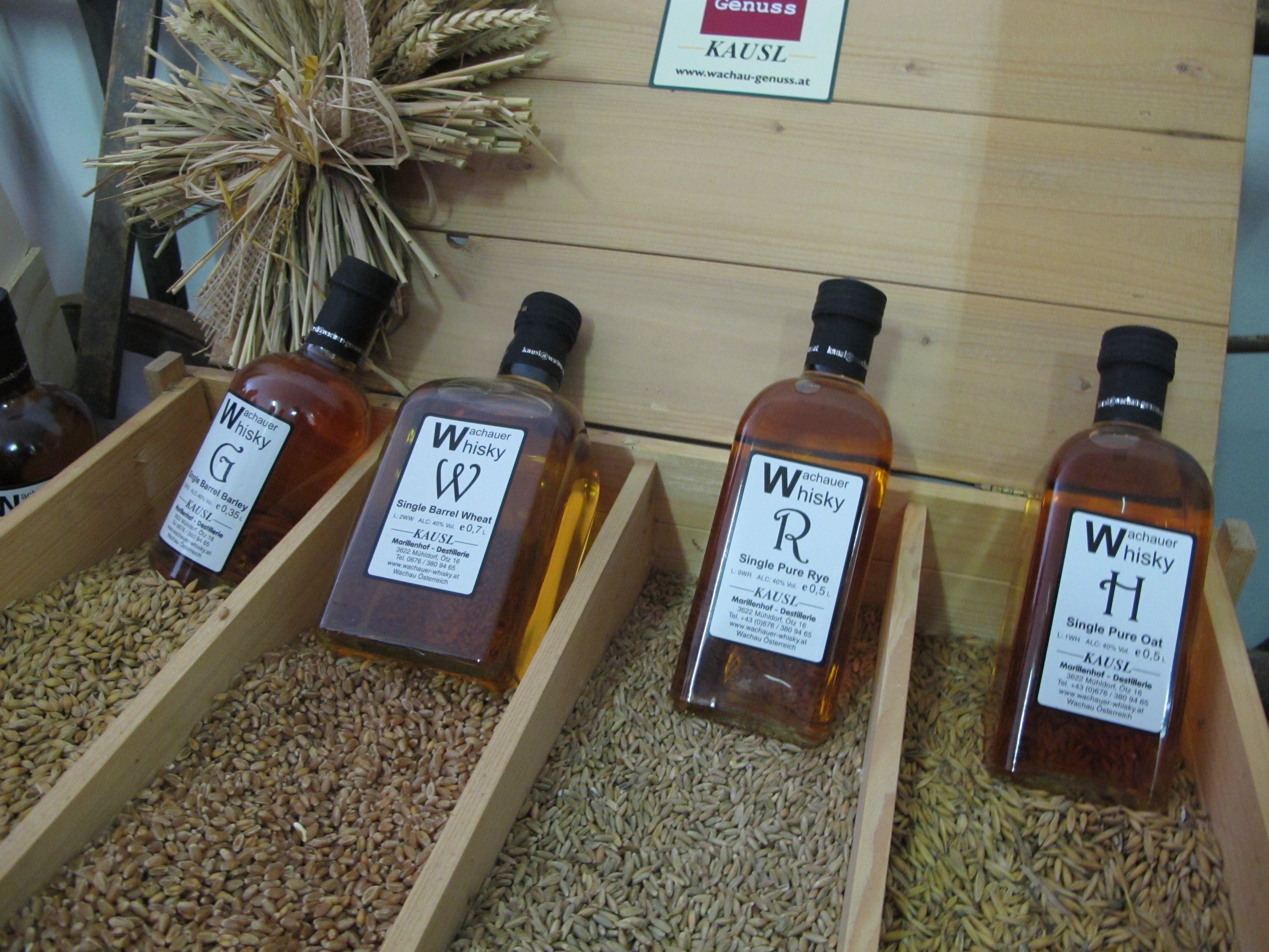 Bottles of Wachau whisky displayed on cereal grains.