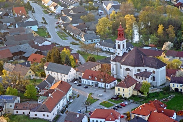 Aerial view of the Hoheneich pilgrimage church in the middle of a village.