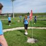 A group of young people playing soccer golf.