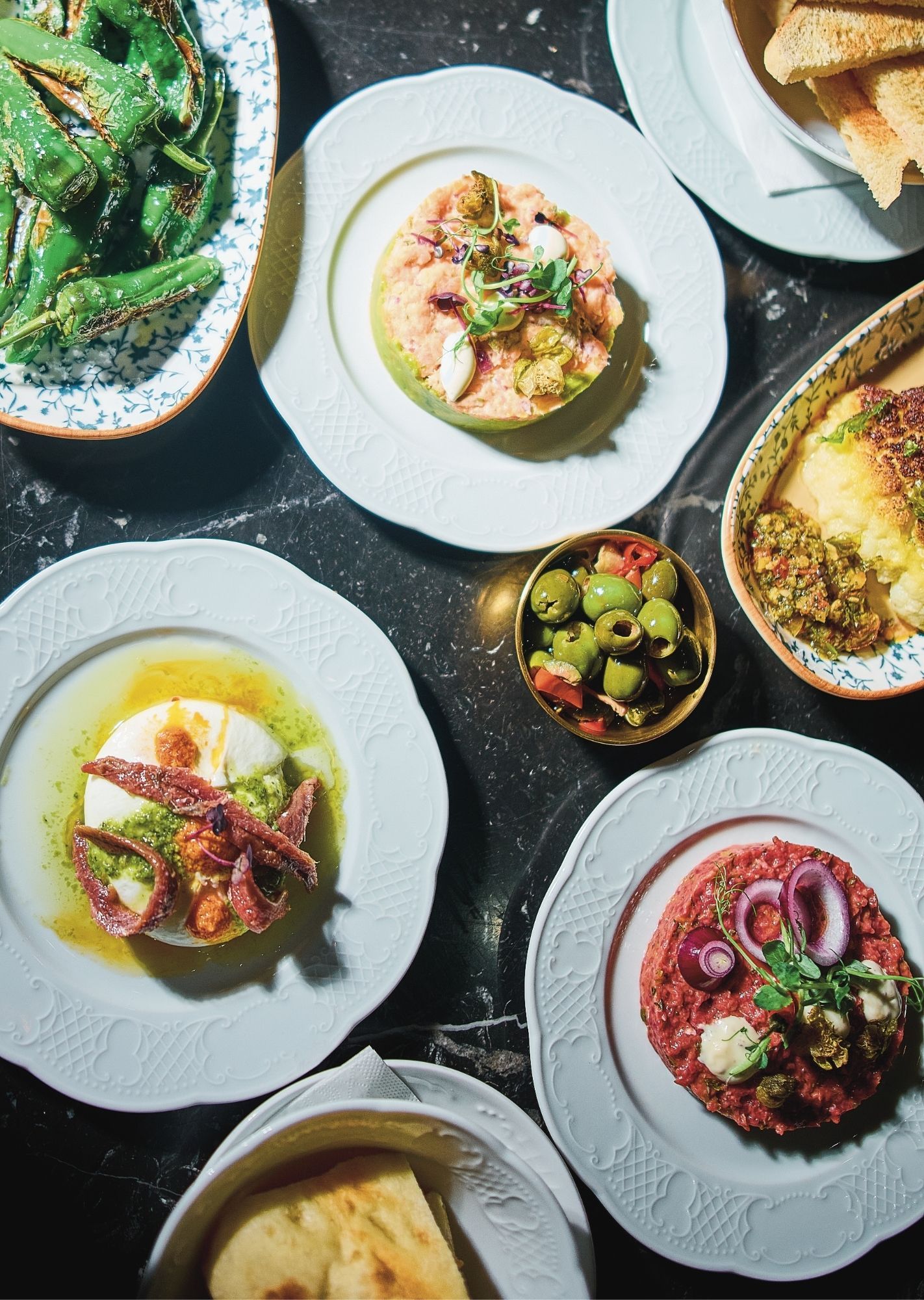 A wide variety of dishes on white plates