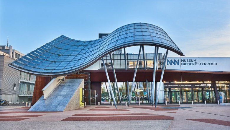 Entrance to the Museum Niederösterreich with modern architecture and curved glass roof.