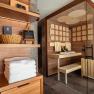 Interior view of a modern sauna with wood paneling and glass front.
