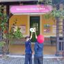 Two children in railroad uniforms stand in front of Dürnstein-Oberloiben station holding up signal boards.