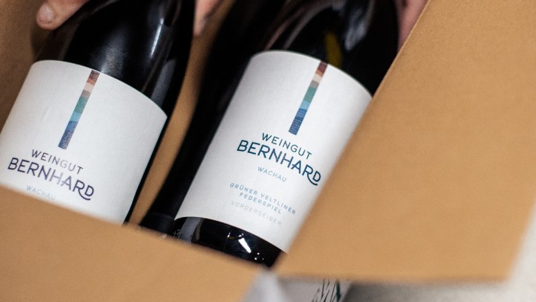 Two bottles of wine from the Bernhard winery in cardboard packaging.