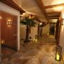 A spa hallway with salt sauna, palm trees, lanterns and wooden elements.