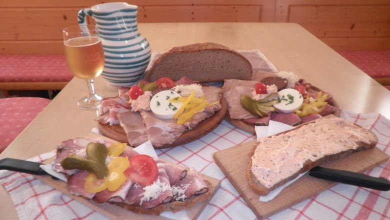 Traditional Austrian snack with bread, cold cuts and a drink.