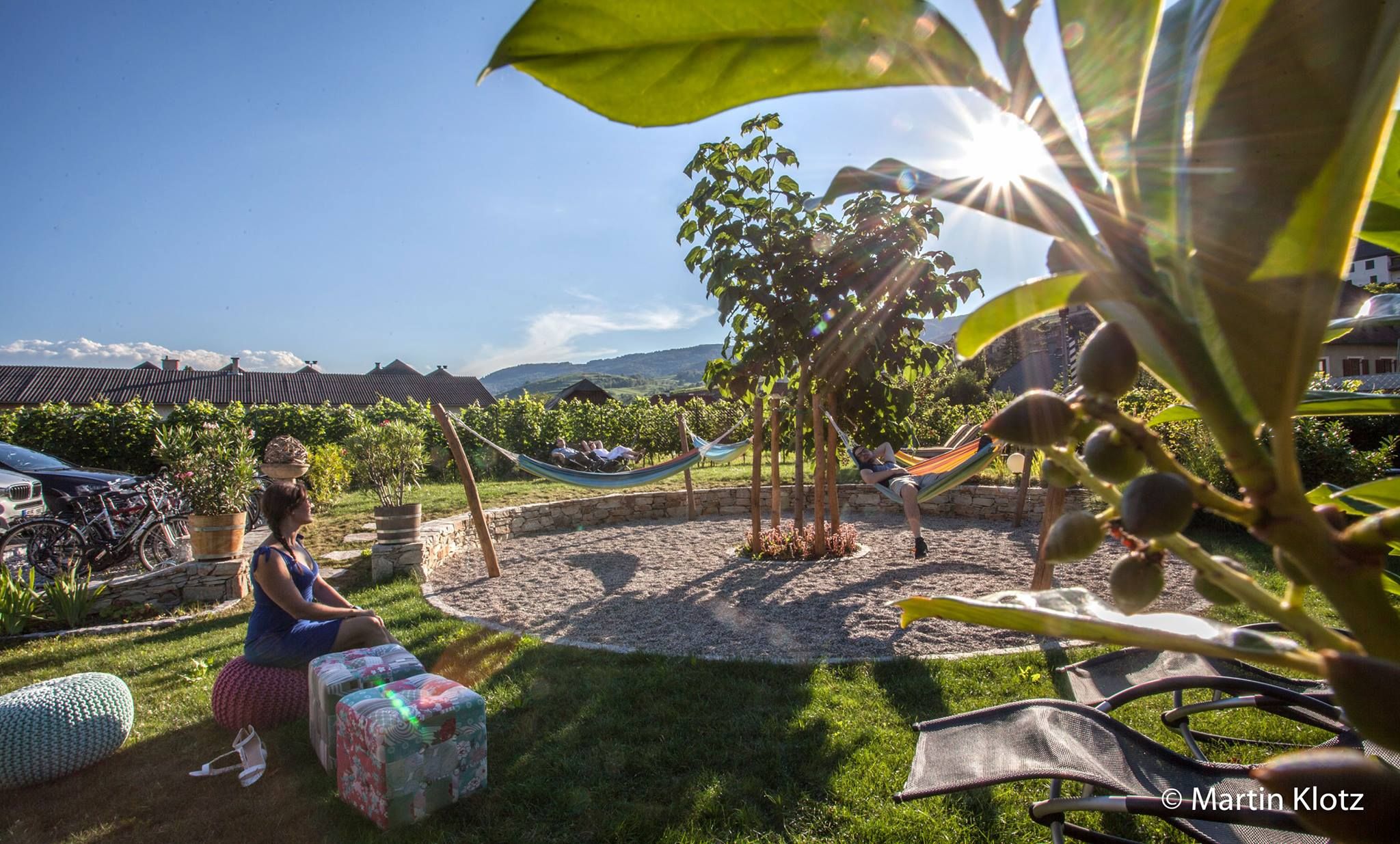Mediterranean garden with hammocks and people relaxing.
