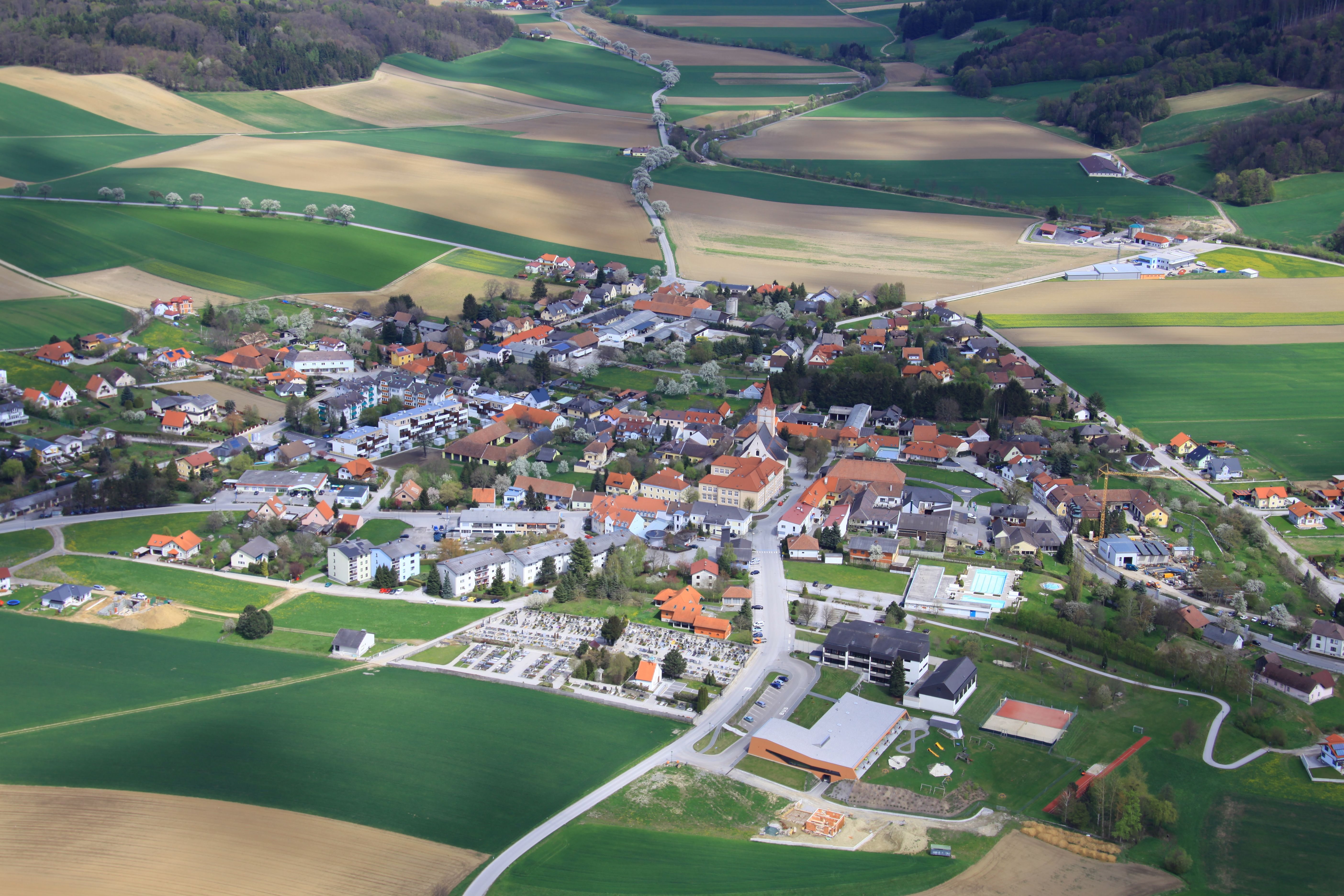 Aerial view of the municipality of Pyhra with fields and buildings.