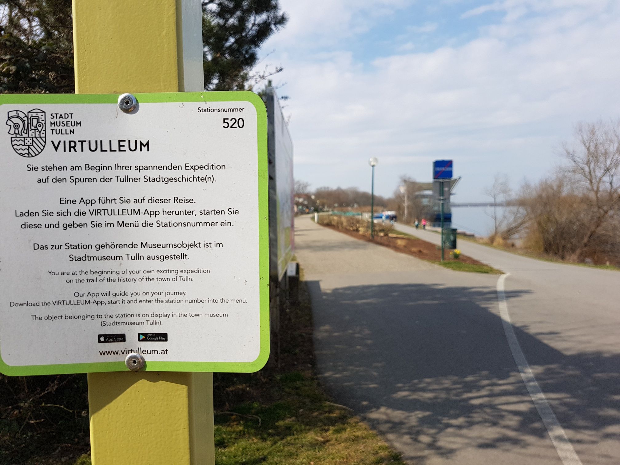 Virtulleum sign in Tulln with path in the background.