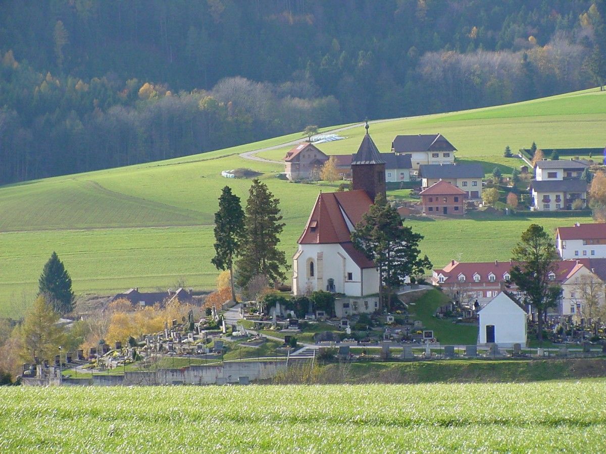Erasmus Church in Krumbach with surrounding cemetery and green landscape.