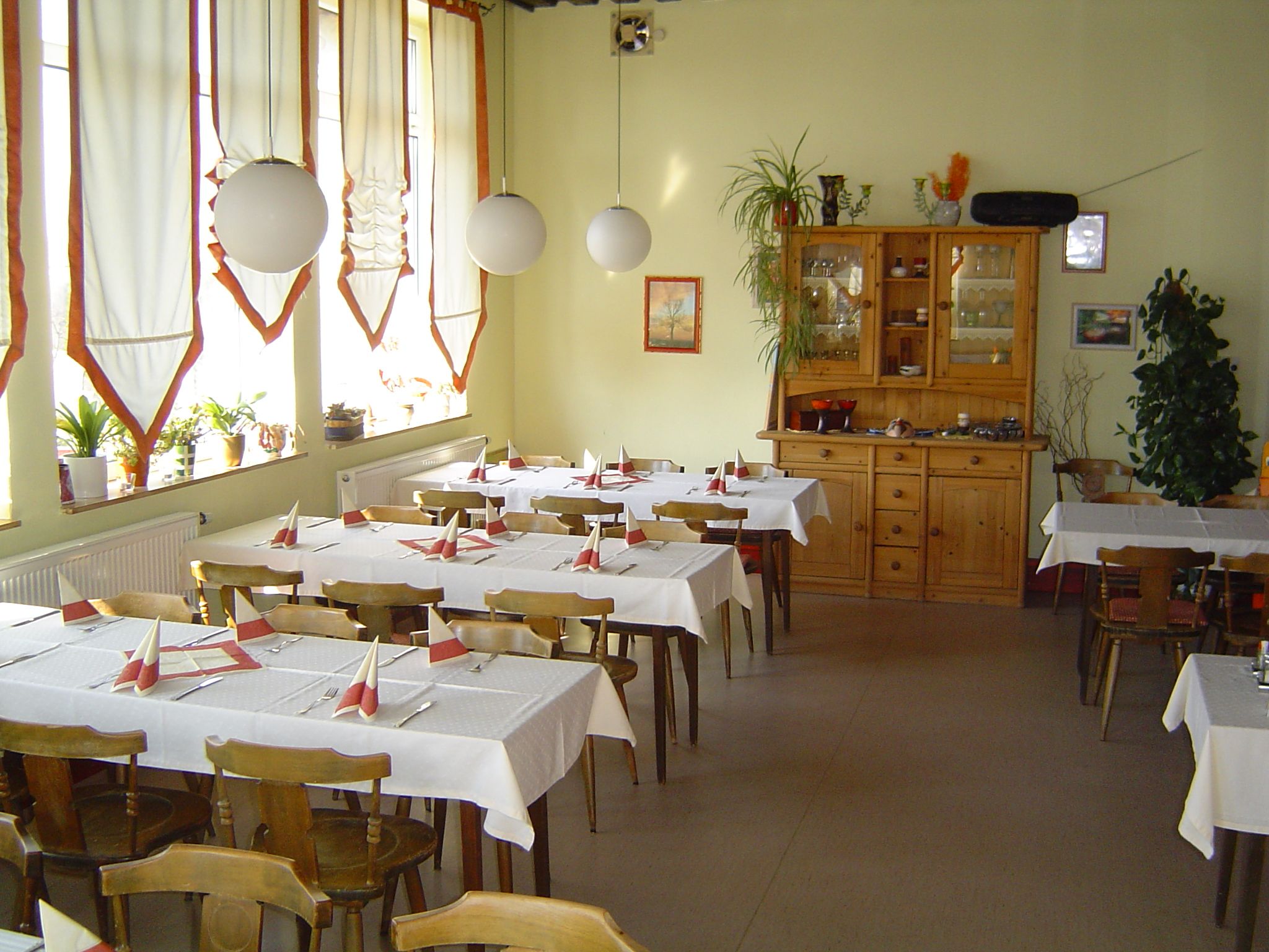 Interior view of a cozy café with wooden furniture and decorated tables.