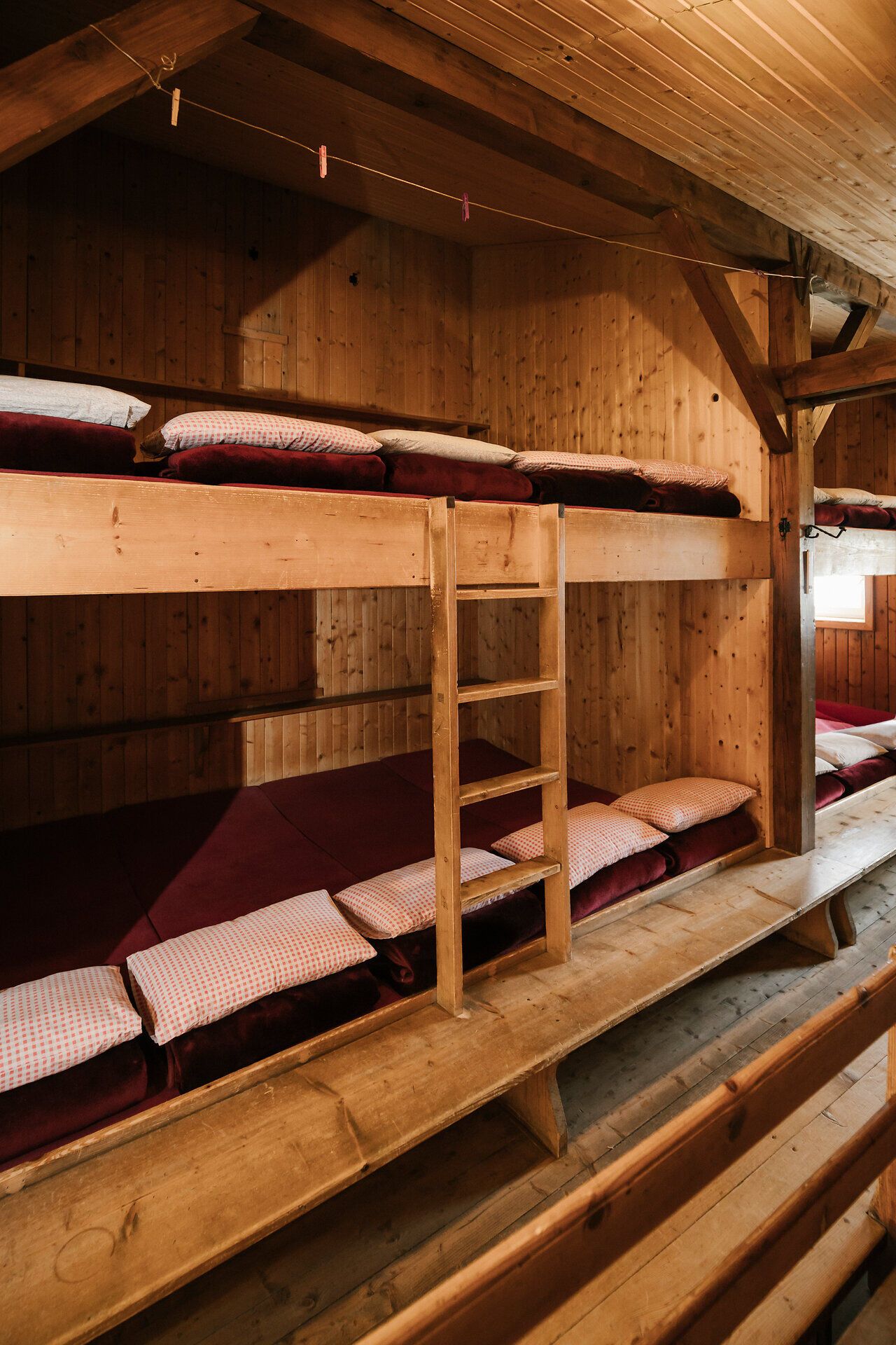 Dormitory-style accommodations in the fishing cabin on Schneeberg, with simple wooden bunk beds