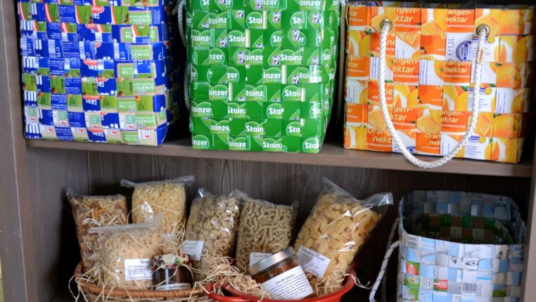 Shelf with woven baskets made from packaging.
