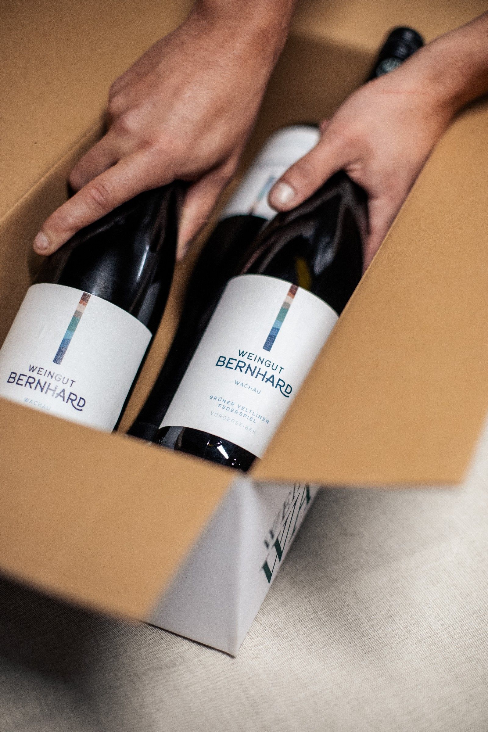 Two bottles of wine from the Bernhard winery in cardboard packaging.