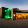 Modern winery with illuminated entrance and large 'Aigner' lettering.