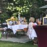 Garden party with decorated tables, flowers and drinks.